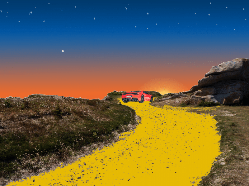 Red Ferrari driving down a golden road into the sunset
